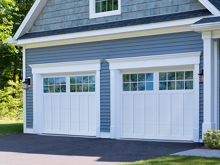 Garaga residential garage door in Ice White with the P-13 design, matching overlays and Panoramic windows.