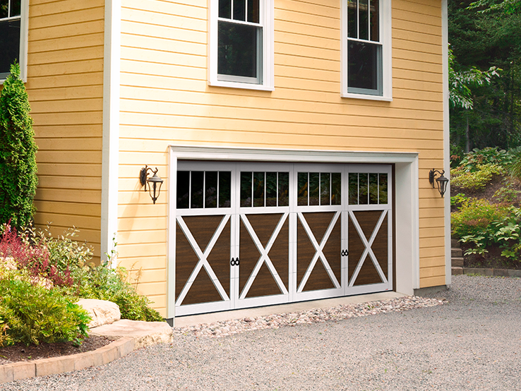 Garaga residential garage door with a Chocolate Walnut faux-wood finish, the P-21 design, Ice White overlays and Panoramic windows.