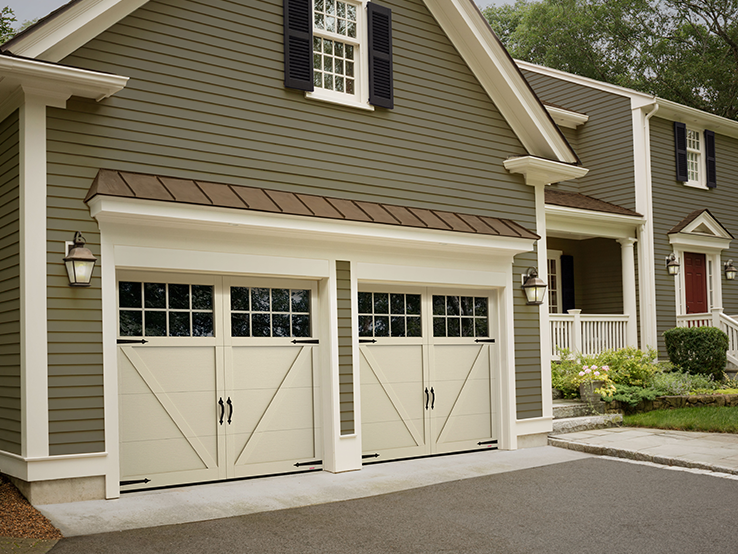 Garaga residential garage door in Desert Sand with the P-23 design, matching overlays and Panoramic windows.