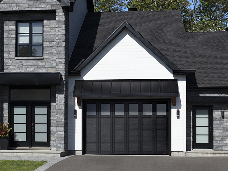 Garaga residential garage door in Black with the P-31 design, matching overlays and Panoramic windows.