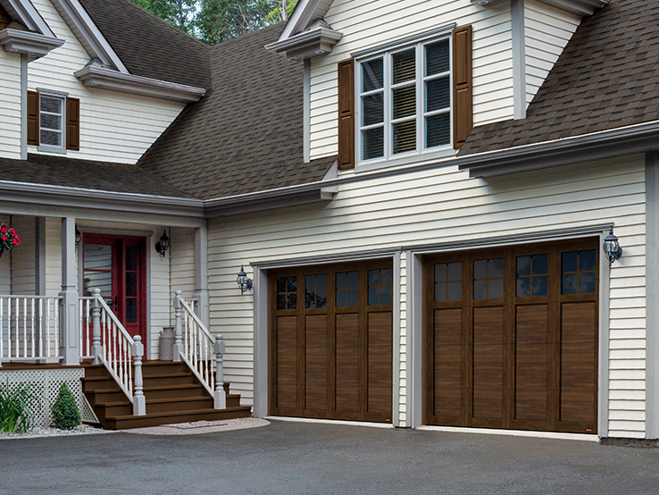 Garaga residential garage door with a Chocolate Walnut faux-wood finish, the P-31 design, matching overlays and Panoramic windows.
