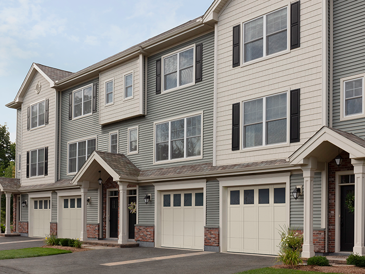 Garaga residential garage door in Desert Sand with the P-31 design, matching overlays and Panoramic windows.