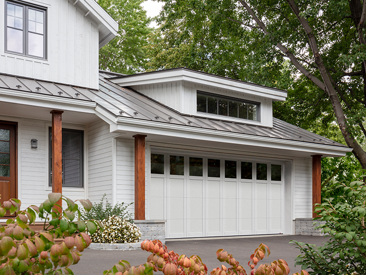 Garaga residential garage door in Black with the P-31 design, matching overlays and Panoramic windows.