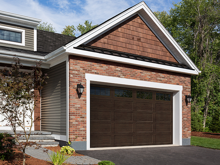 Garaga residential garage door with a Dark Walnut faux-wood finish, the Recessed Long design and Richmond window inserts.