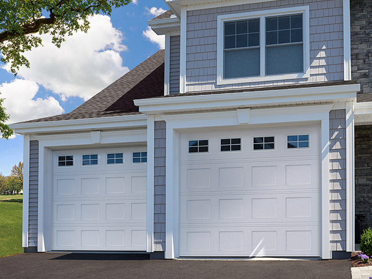 Garaga residential garage door in White with the Recessed Short design and Stockton window inserts.