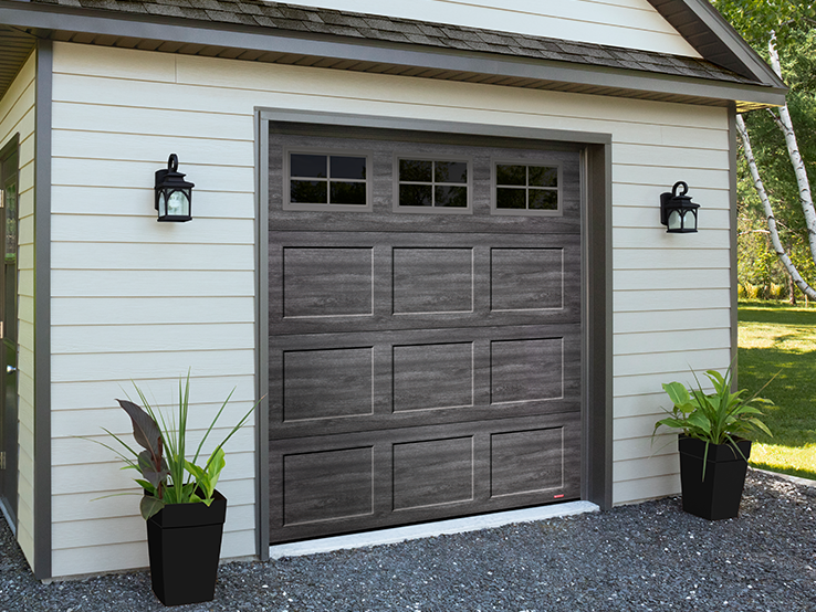 Garaga residential garage door with a Weathered Grey faux-wood finish, the Shaker-Flat CC design and Orion windows.
