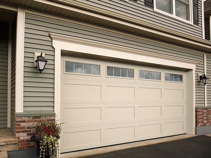 Garaga residential garage door in Desert Sand with the Shaker-Flat XL design and Orion windows.
