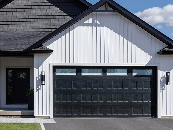 Garaga residential garage door in Black with the Shaker-Flat XS design and White Sandblasted glass.