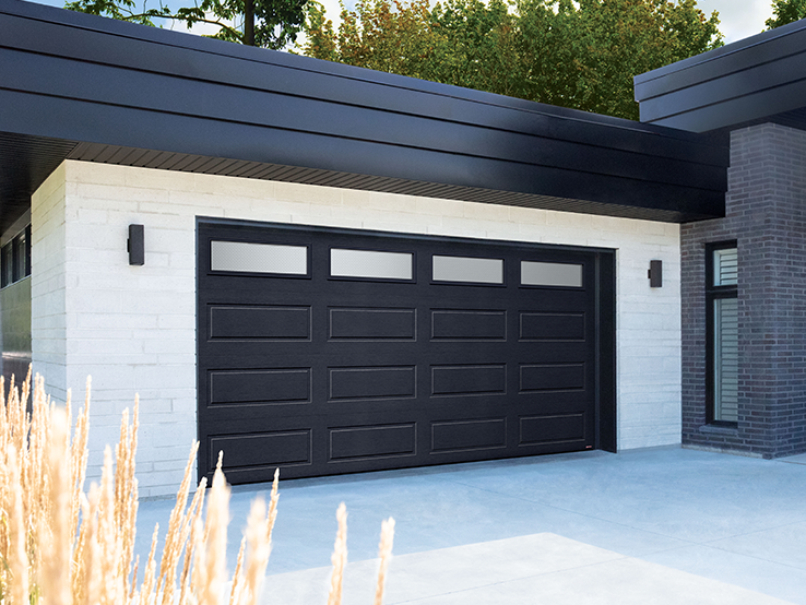 Garaga residential garage door in Black with the Shaker-Modern XL design and White Sandblasted glass.