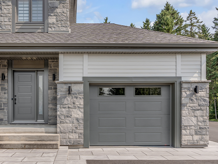 Garaga residential garage door in Charcoal with the Shaker-Modern XL design and windows.