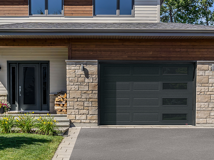 Garaga residential garage door in Iron Ore with the Shaker-Modern XL design and Harmony windows with Black Satin glass.