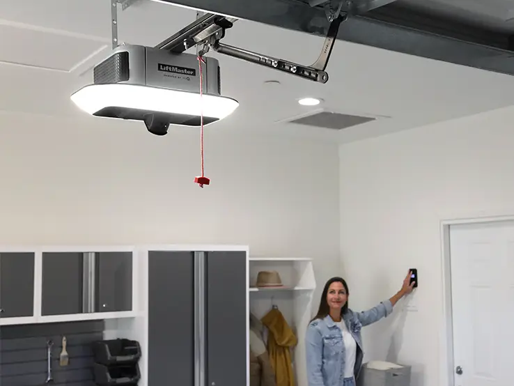 Femme surveillant son garage avec la caméra intégrée du LiftMaster 6690L.