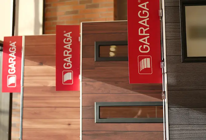 Three Garaga garage door models on display in the showroom
