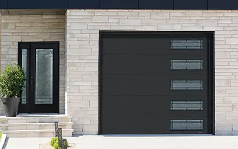 Modern home with a sleek black flush garage door featuring windows with Celeste glass.