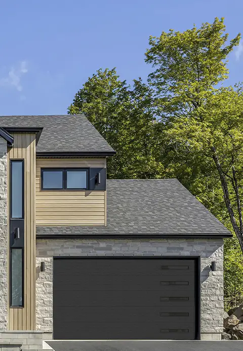 Modern home with a Garaga black contemporary garage door featuring clean horizontal grooves.