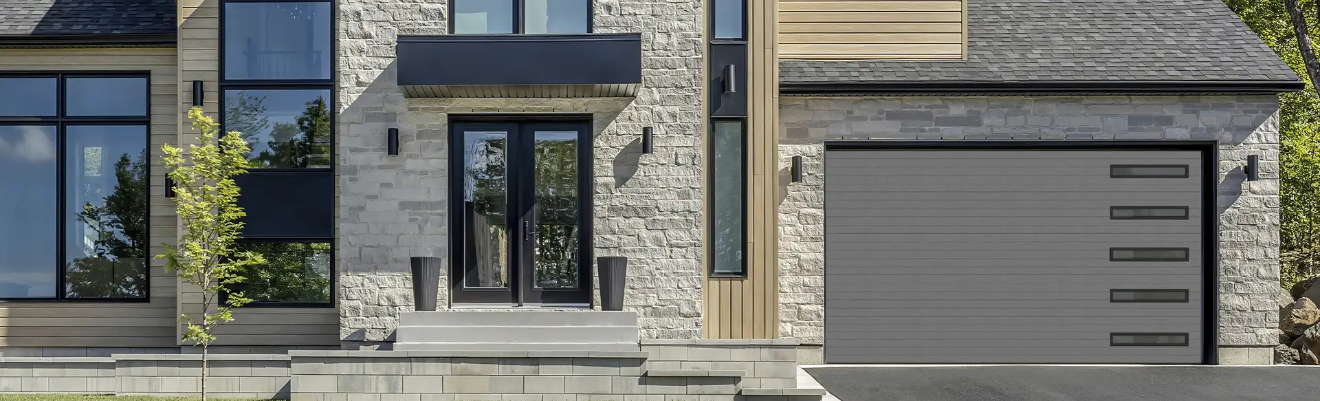Modern home with a Garaga charcoal contemporary garage door featuring clean horizontal grooves.