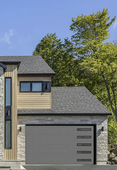 Modern home with a Garaga charcoal contemporary garage door featuring clean horizontal grooves.